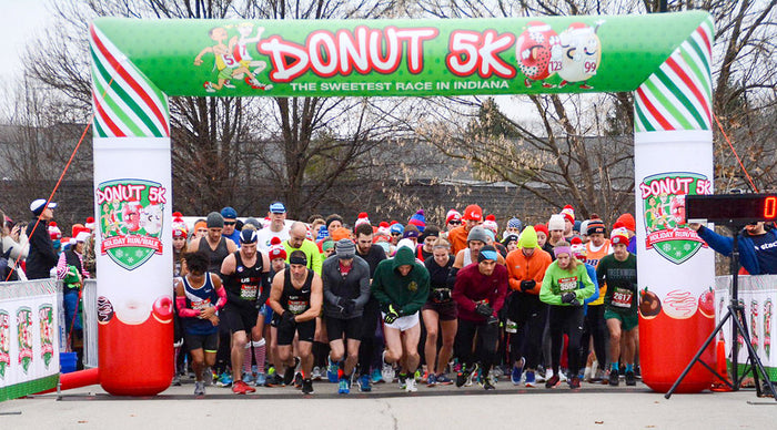 Runners and walkers participating in the Donut 5K Holiday Run/Walk in Carmel, Indiana